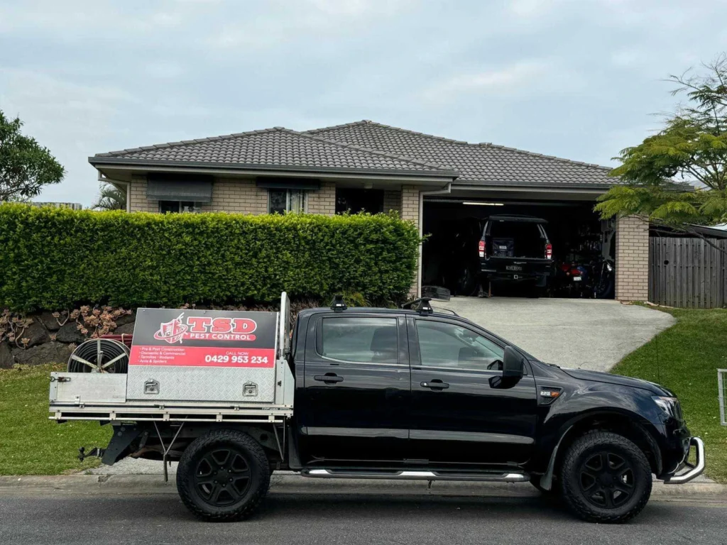 TSD Pest Control truck parked at a Banora Point home, equipped for pest treatment and extermination services.