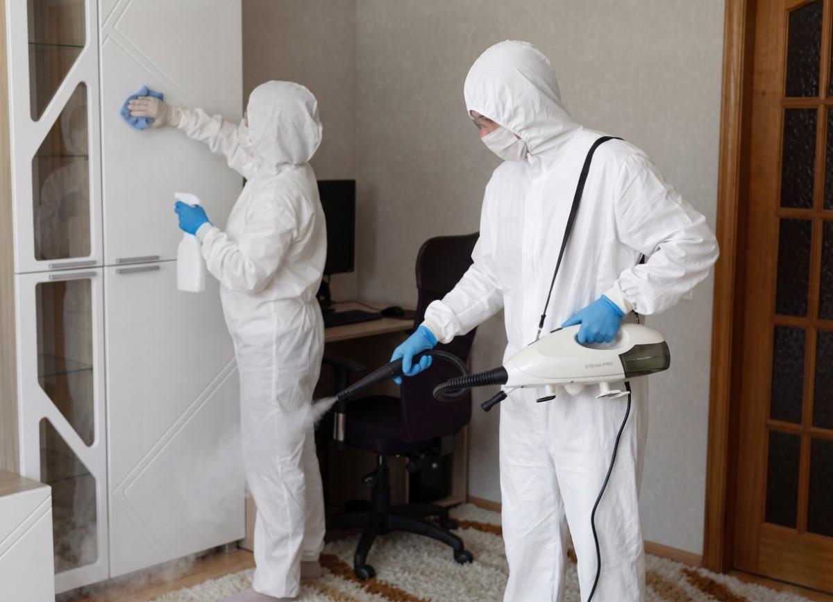 Pest control technician inspecting a newly built house before family move-in