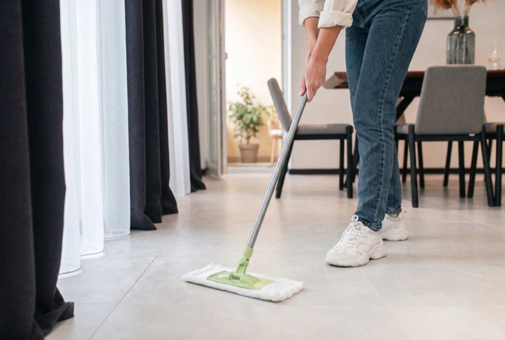 Mopping the floor after pest control in Banora Point for effective cleaning.
